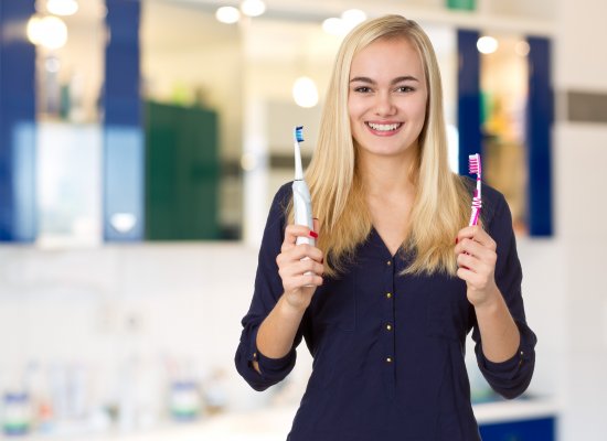 Electric toothbrushes in womans hands